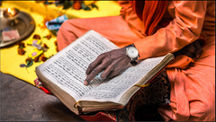 Person in orange robes reading a book with a yellow cloth and objects in the background

Spiritual Guidance